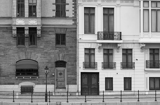 Black and white reflection of office buildings on the glass wall, background with copy space, full frame horizontal composition