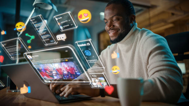 istock African American Project Manager Working on Computer in Office. Augmented Reality Social Media Icons Appear From Worker's Laptop. Internet of Things, Internet Connectivity and Online Concept. 1461626239