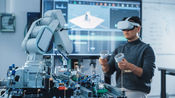 Computer Science Engineer in Virtual Reality Headset Using Controllers and Operating Robot Arm Under his Control. VFX Augmented Reality Icons Demonstrate Innovative Technologies Concept. Computer Science Engineer in Virtual Reality Headset Using Controllers and Operating Robot Arm Under his Control. VFX Augmented Reality Icons Demonstrate Innovative Technologies Concept. ai research stock pictures, royalty-free photos & images