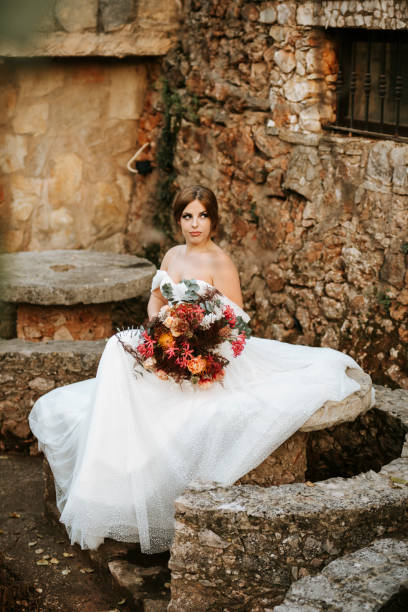 istock Beautiful bride with her bouquet sititng in the  garden 1461627388