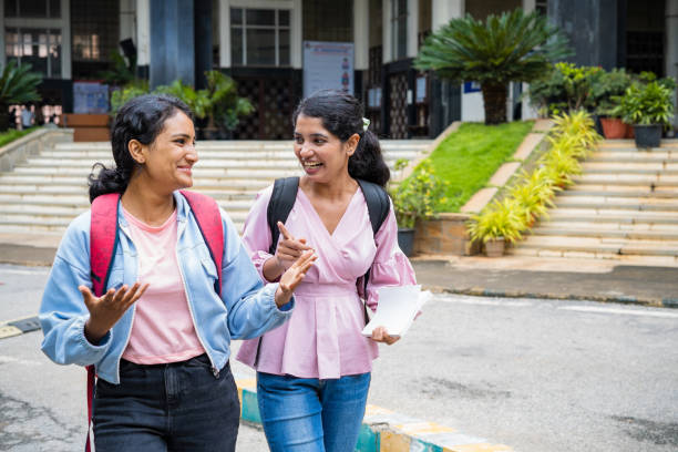 istock Happy smiling college students talking each other after classes at college campus - concept of taking break, friendship and education. 1461631407