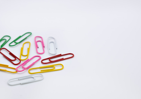 Multicolored paper clips on a white background