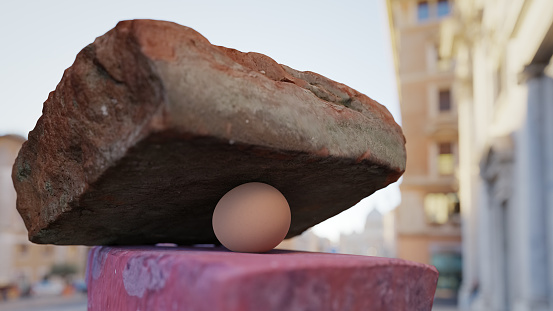 It could break, it won't break: an egg under a brick. CGI