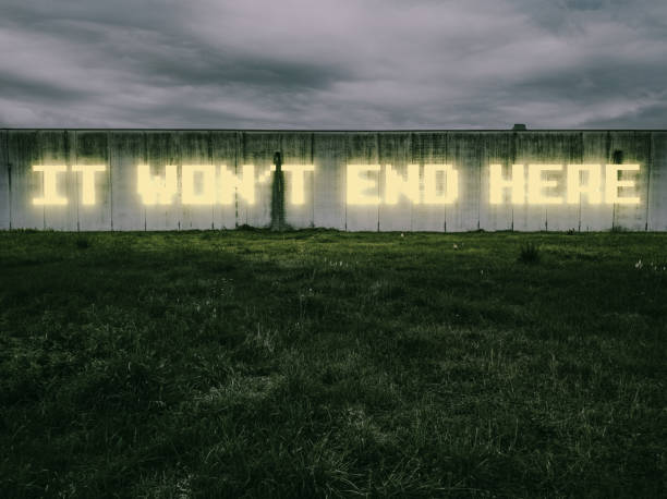 It won't end here "It won't end here", says a neon sign across a large industrial wall. *** The text was digitally superimposed and a release is provided *** vendetta stock pictures, royalty-free photos & images