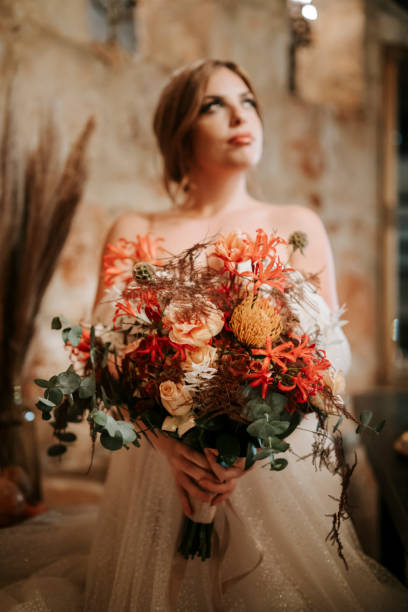 istock Portrait of beautiful bride with  bouquet in rustic settings 1461632489