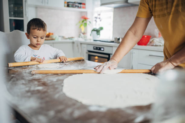 istock Grandma and grandson are preparing dough for baking in the kitchen 1461632552