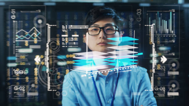 istock Young Adult Male Engineer Using Futuristic Augmented Reality Software Interface for Managing Work Projects. Japanese Specialist Researching Analytical Data Graphs with Different Parameters. 1461634499
