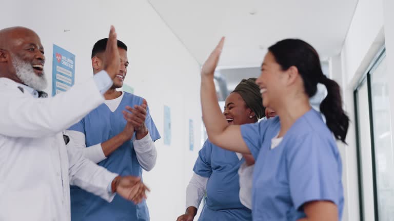 Doctors, hands together and team with support, motivation applause and high five for health. Solidarity, diversity and commitment with trust, happy and medical collaboration and medicine.