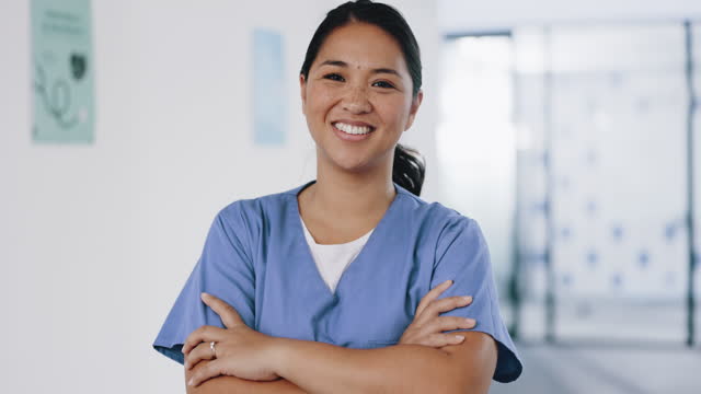 Nurse, face or arms crossed in hospital clinic with wellness motivation, medical research trust or surgery planning motivation. Portrait, smile or happy healthcare worker with confidence in Indonesia