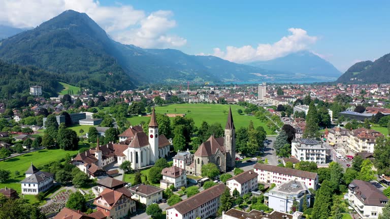 Aerial view over the city of Interlaken in Switzerland. Beautiful view of Interlaken town, Eiger, Monch and Jungfrau mountains and of Lake Thun and Brienz. Interlaken, Bernese Oberland, Switzerland.