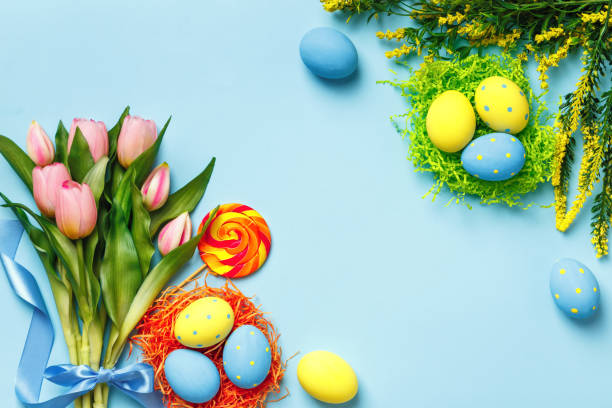 istock Greeting card Easter eggs flowers bouquet of tulips on a blue background with copy space. 1461639475