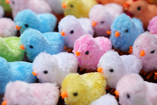Fluffy pink, yellow, blue and green, small fake easter chicks background