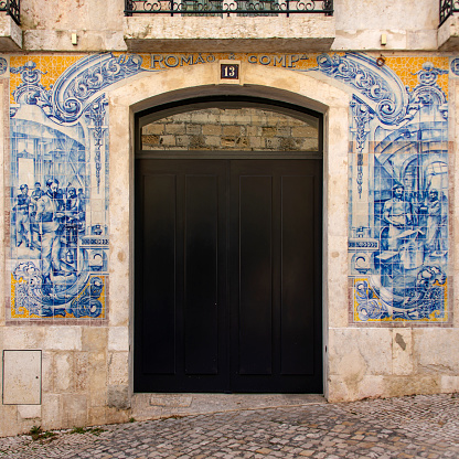 Antique azulejos in the facade of a former blacksmiths workshop in Bairro Alto, Lisbon.