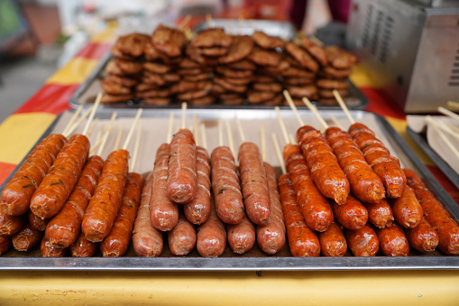 Close-up of BBQ style pork sausage, Traditional Asian Street food being prepared by the roadside.