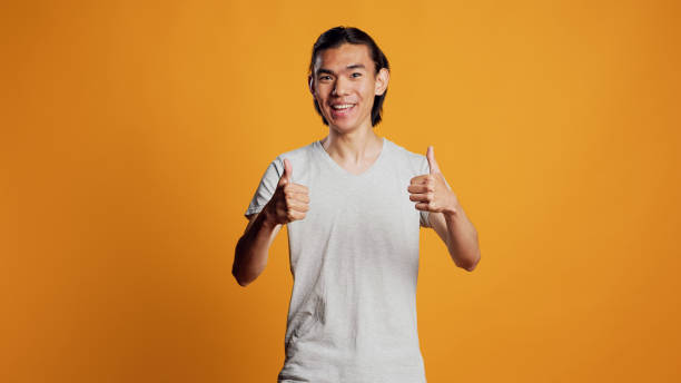 istock Carefree guy giving thumbs up on camera 1461645215