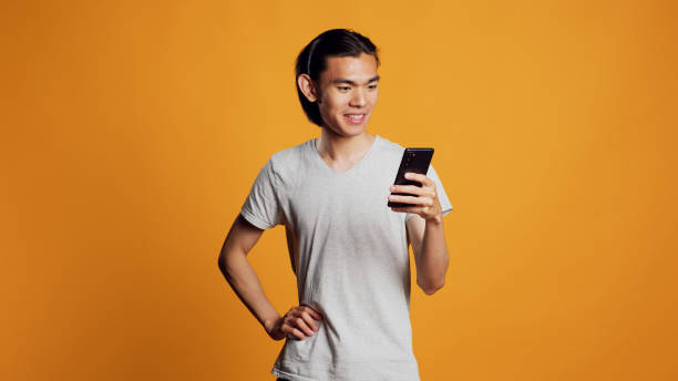 istock Modern young adult browsing internet on smartphone 1461646302