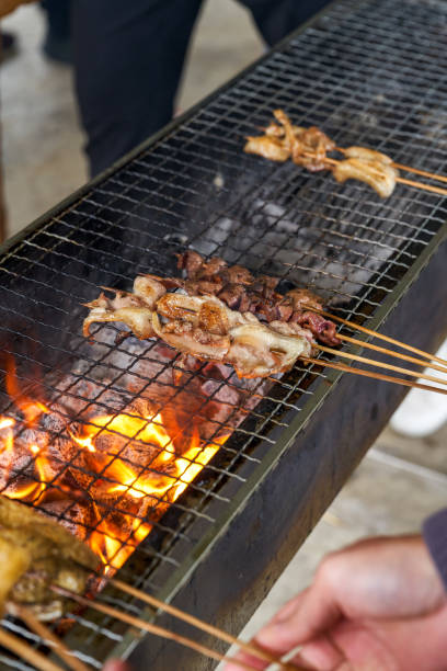 istock A group of people are sitting outdoors around a strong charcoal fire and grilling 1461647255
