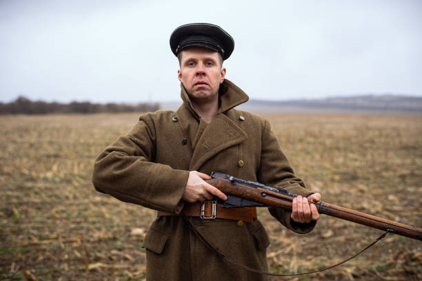 istock retro soldier with a rifle in his hands is looking at the camera 1461648544