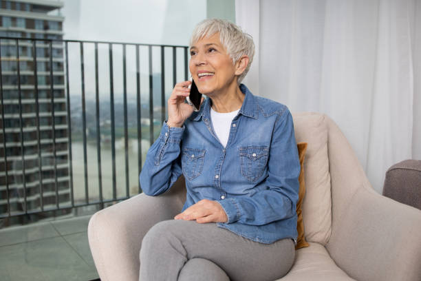 istock Happy senior woman using phone 1461649760