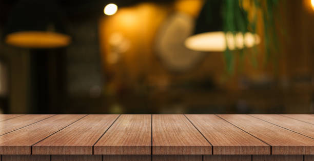 istock Empty wooden table top with lights bokeh on blur restaurant background. 1461649779