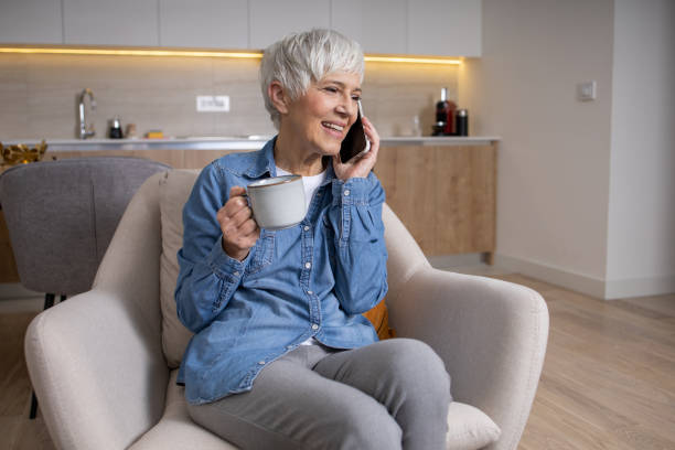 istock Happy senior woman using phone 1461649784