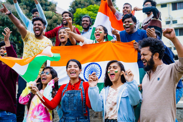 istock Group of audience at stadium shouting, screaming for win by holding indian flags while watching crcket sports match at stadium - concept of entertainment, championship tournament and entertainment 1461650610
