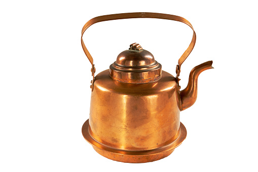 Old copper teapot covered with patina.Isolate on a white background.