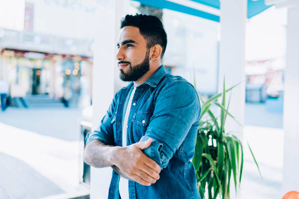 Ethnic male relaxing in summer cafe