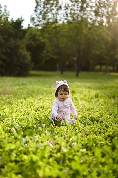 istock child exploring the world of nature sitting in grass. 1461653840