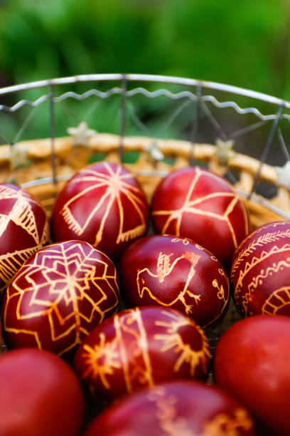 istock Defocus Closeup of basket of colored red eggs, Easter holiday concept. Modern painted easter eggs. Collection of pysanka or krashanka. Out of focus 1461655112