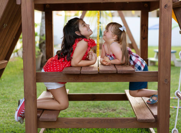 istock Friends playing on playground furniture 1461655600
