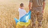 Military man, child with Ukraine flag