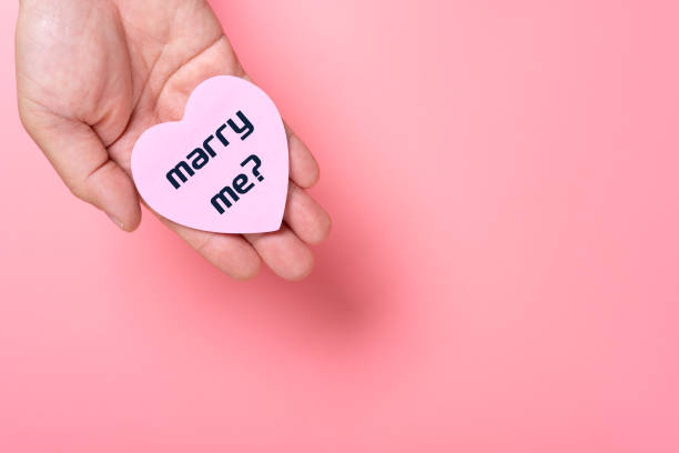 istock man holding a heart shape paper written with marry me 1461657812