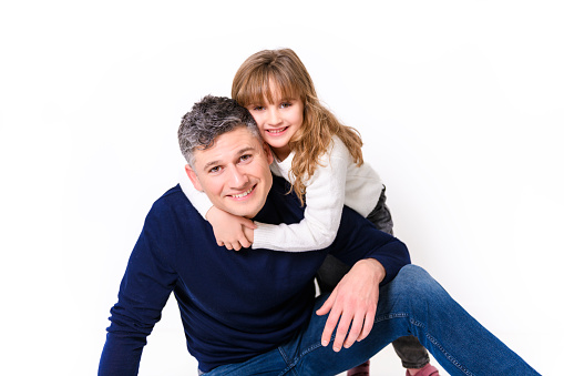A Daughter and father having fun on studio portrait