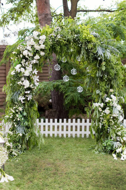 istock Green garden wedding arch with flowers 1461658763