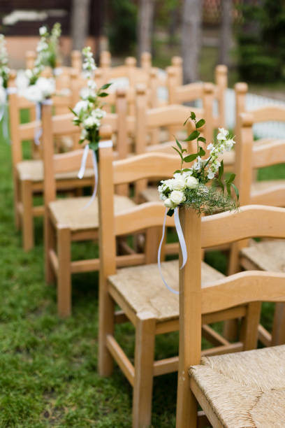 istock Wooden chairs with flowers wedding ceremony 1461658878