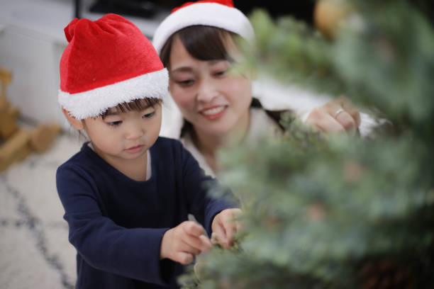Parents and children with Christmas tree decorations
