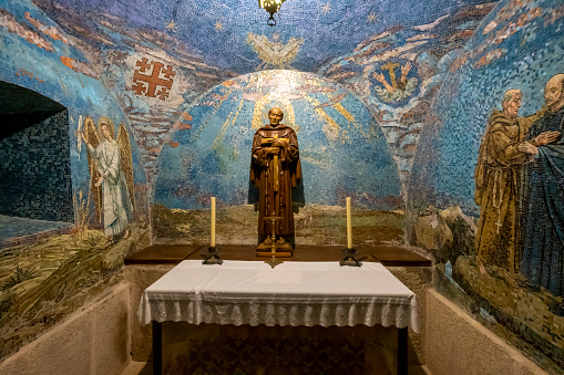 Pedroso de Acim, Spain. - March 25, 2022: A colorful mosaic decorates the walls of this small chapel with an altar and figures of saints and angels, inside the convent of El Palancar. The smallest in the world.