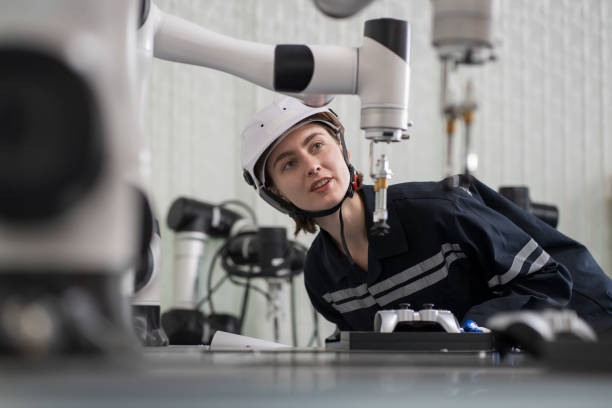 istock Female engineer control autonomous mobile robot or AMR in the laboratory room. Woman engineer training or maintenance AI robot 1461659715