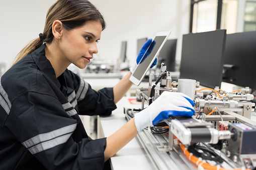 Female engineer training Programmable logic controller with AI robot training kit and mechatronics engineering in the laboratory room
