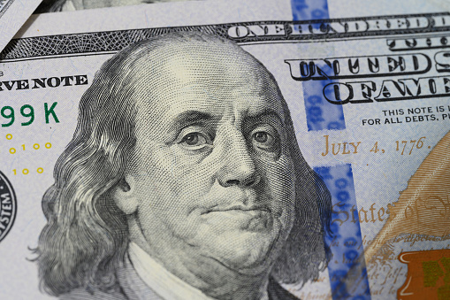 Fragment of one hundred dollar bill with a portrait of Benjamin Franklin