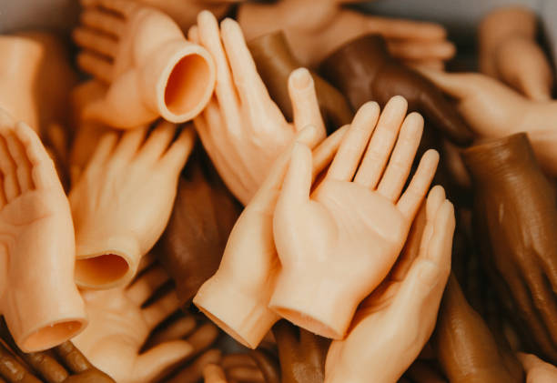 Moment of weightless. Two painted hands trying to touch each other isolated on dark studio background in neon light. Concept of human relation, community, togetherness, symbolism, culture and history