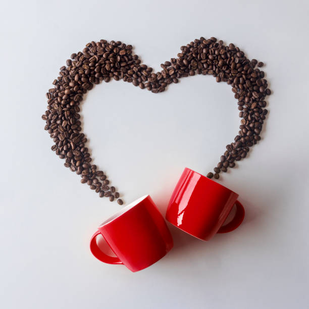 istock Coffee lover. Top view of red  cup and Coffee beans arranged in a beautiful heart shape on white background.  Festive card for Valentines Day. top view. flat lay. 3D illustration 1461663990