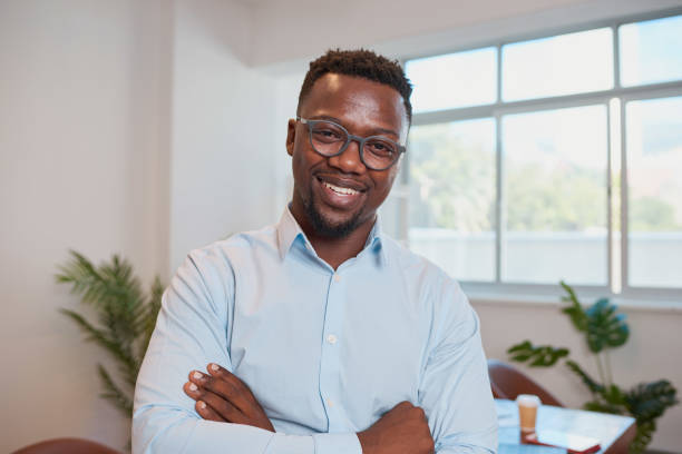 istock Close up Black businessman poses with arms folded in office 1461664688