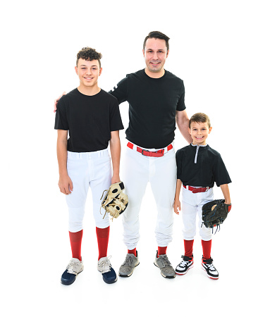 A teen and brother baseball player with dad on Studio shot over white.