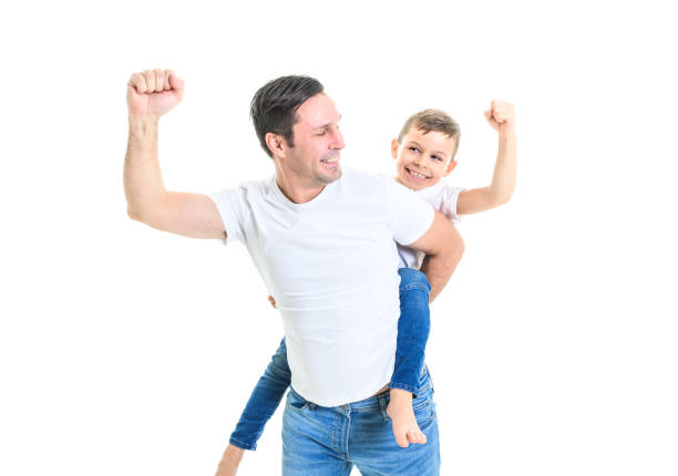 Father carrying kid on his back, child sitting on dads shoulders quality family time outdoors