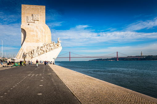 Lisbon, Portugal - November 02, 2022: view of Padrao dos Descobrimentos (Monument to the Discoveries). Located near Tagus River and the april 25th bridge in background.