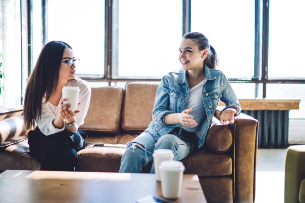 istock Young women speaking and drinking coffee in cafe 1461670604