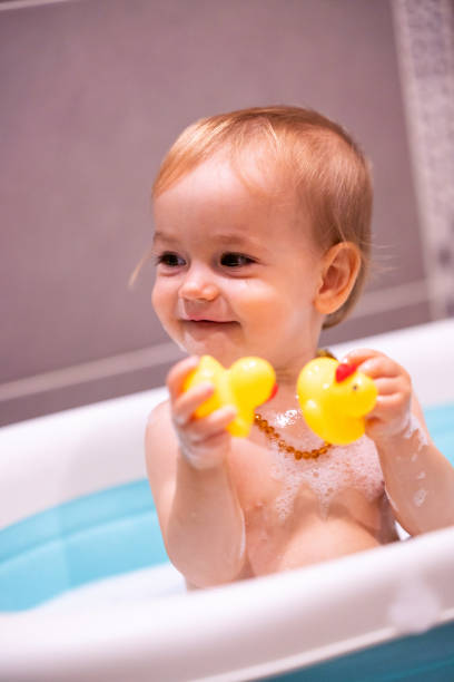 istock Happy baby girl is having a bath 1461670814