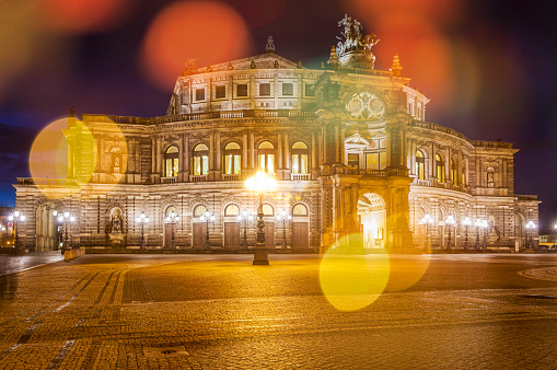 The artificially illuminated facade of the Semper Opera House in Dresden, the capital of Saxony at night photographed from the publicly accessible Theaterplatz in a long time exposure
